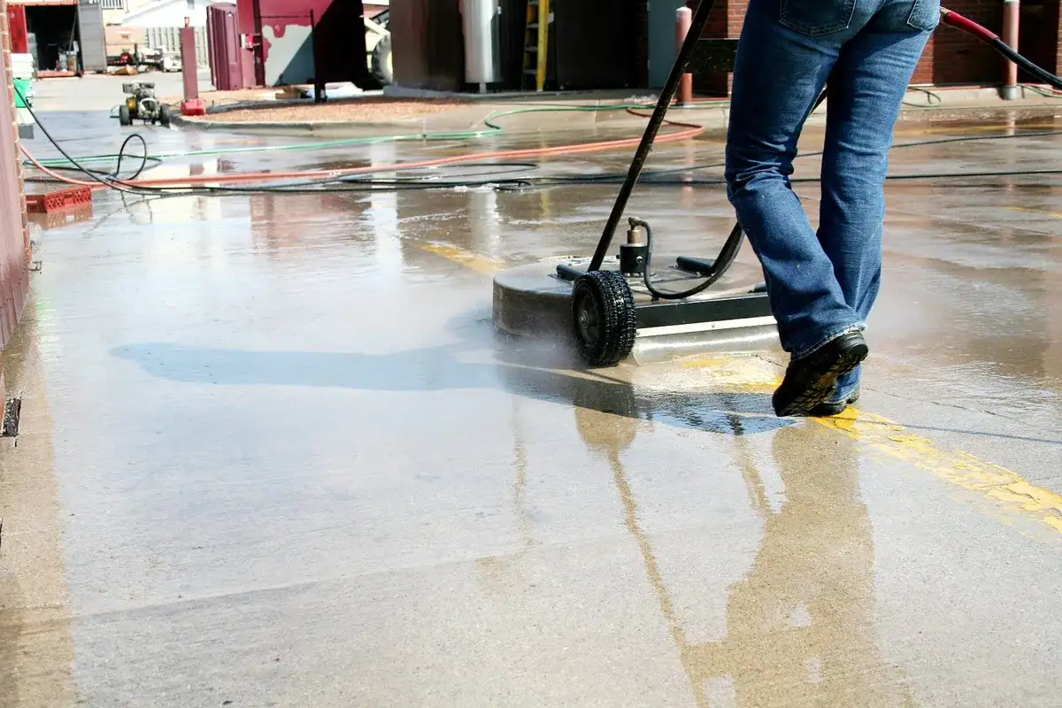 Commercial surface cleaner washing a paved business area